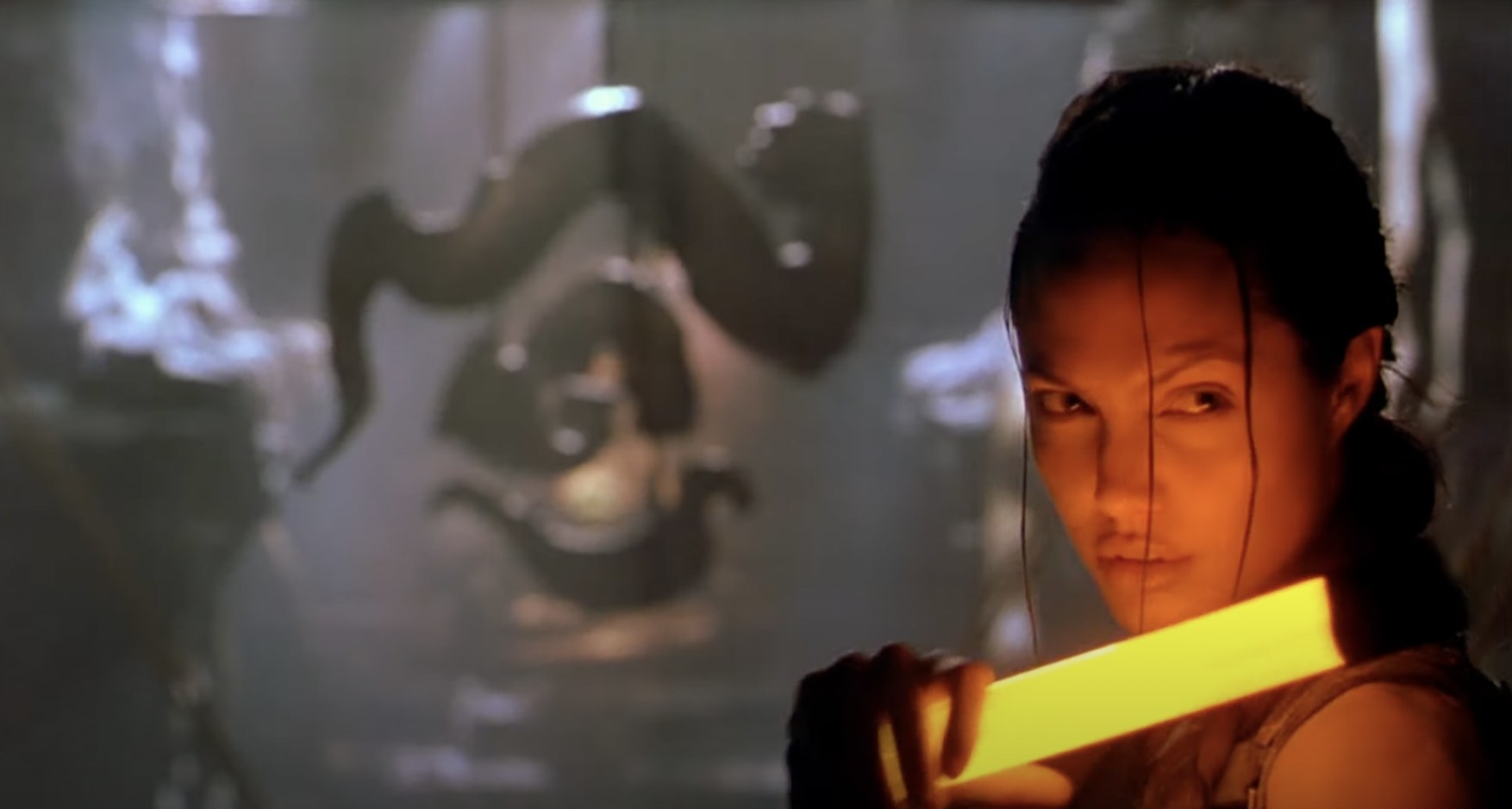 Lara Croft uses a glow stick light in a cave