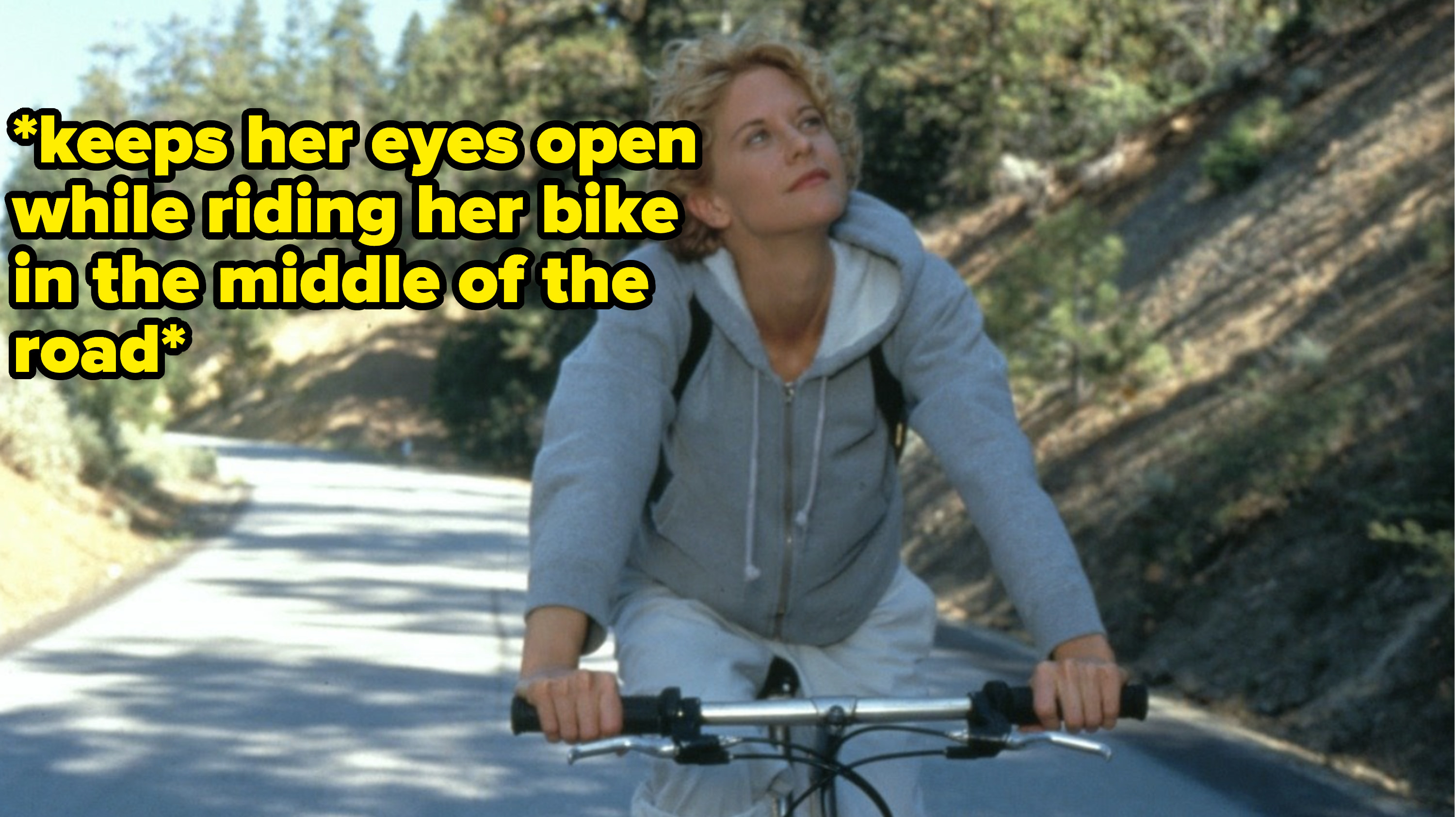 maggie in city of angels riding her bike with text that reads keeps her eyes open while riding her bike in the middle of the road