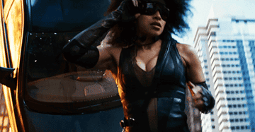Domino runs in slow motion while a car blows up behind her
