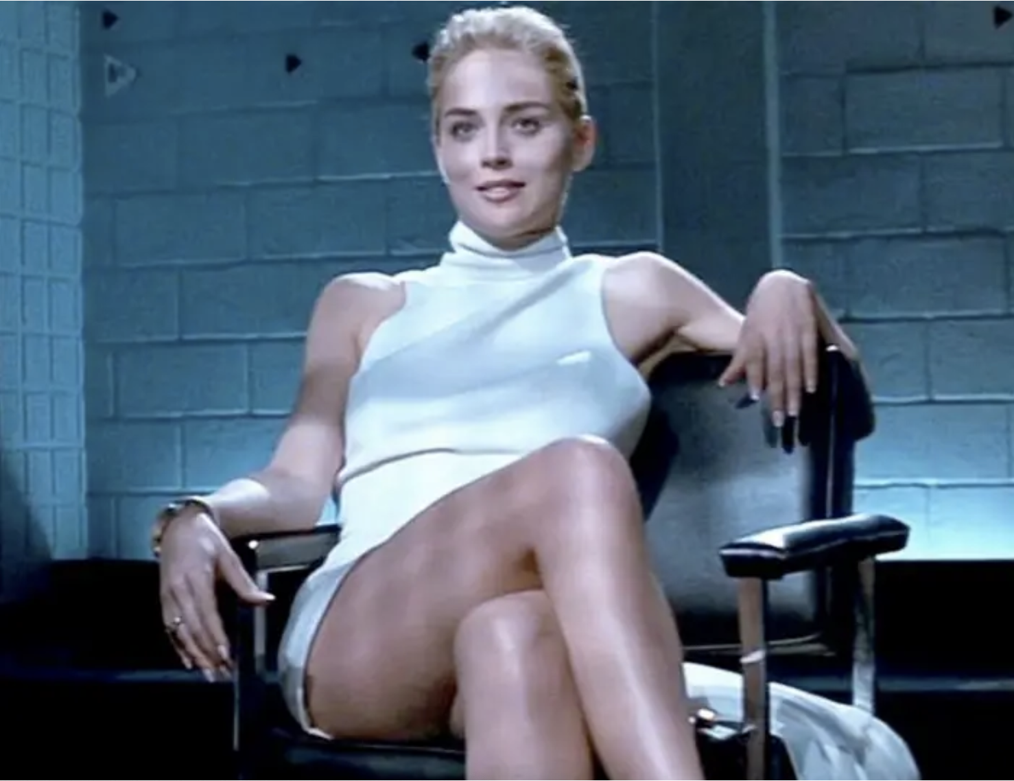 Screenshot from &quot;Basic Instinct&quot; of her sitting cross legged in the chair