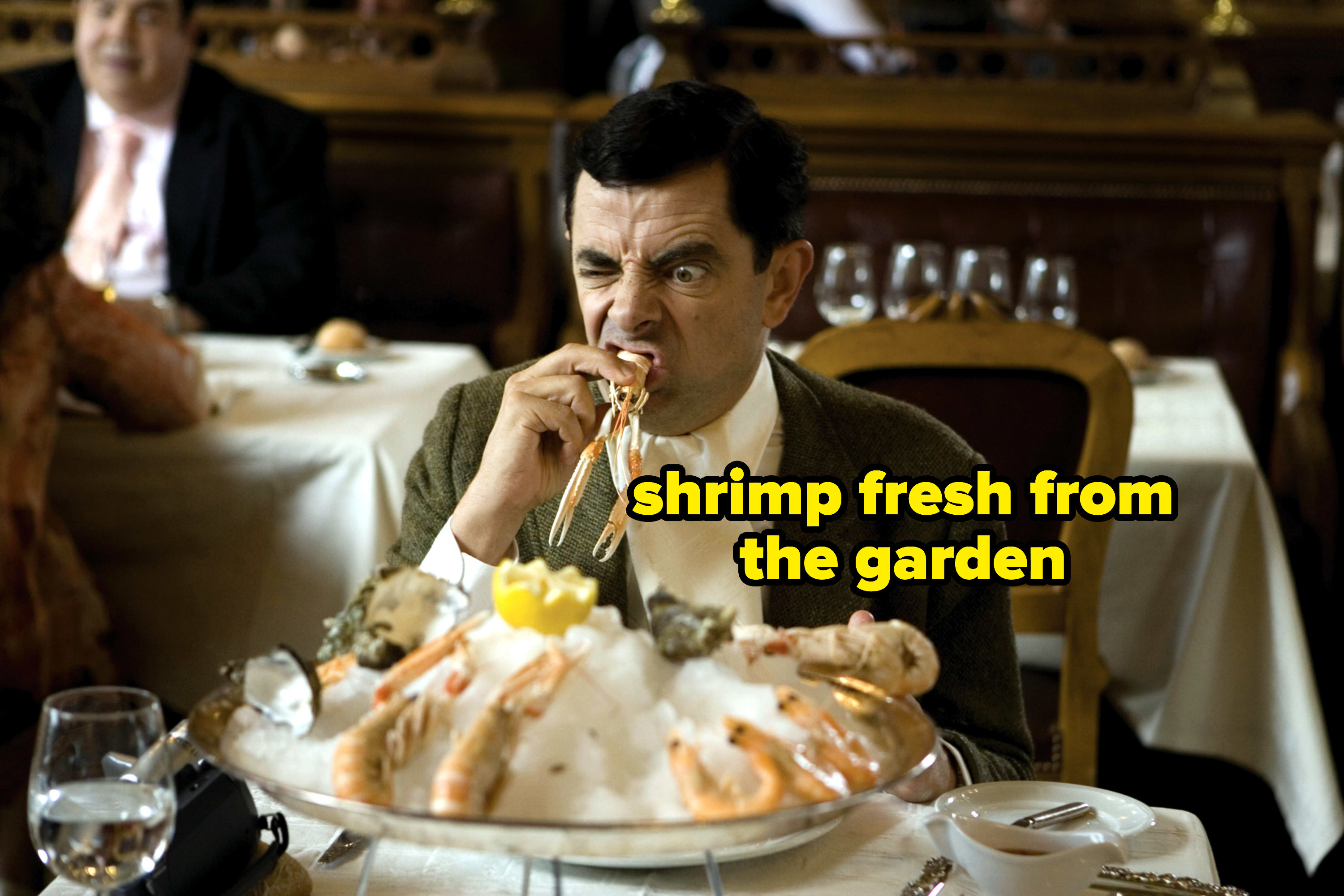 person eating a large plate of shrimp and oysters with text reading, shrimp fresh from the garden