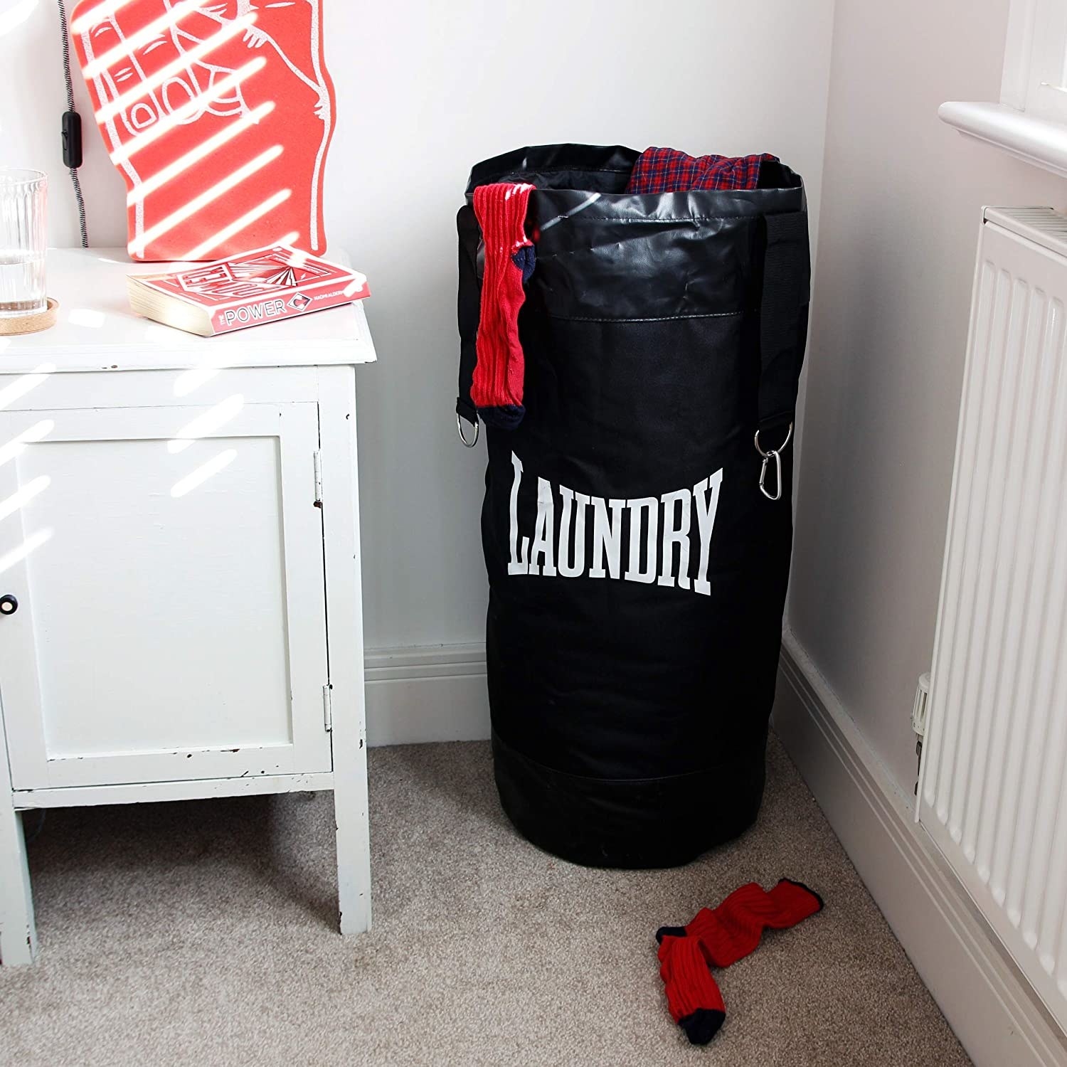 a punching bag hamper that says laundry on it in the corner of a room