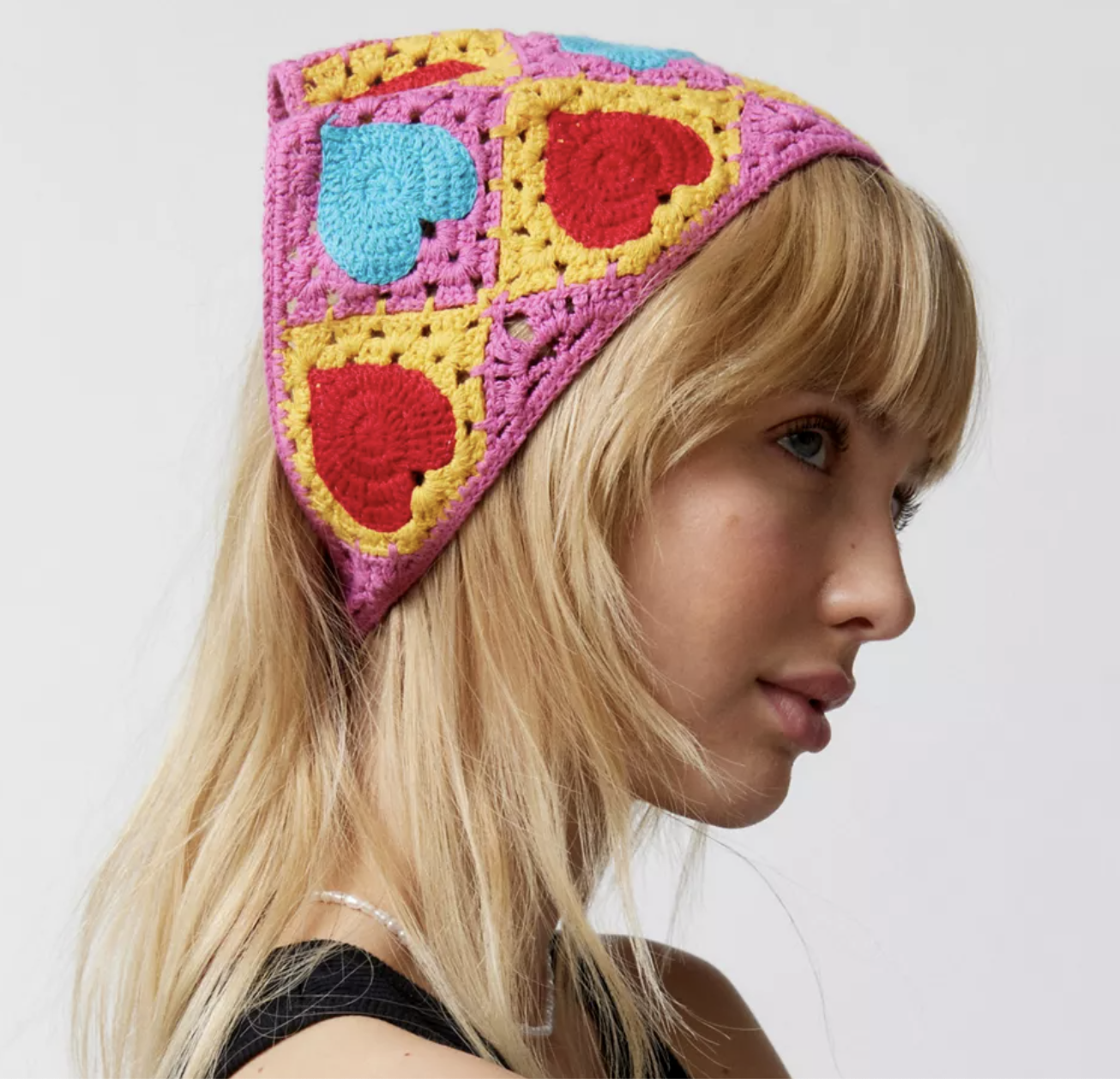 A model wearing the bandana in their hair in front of a plain background