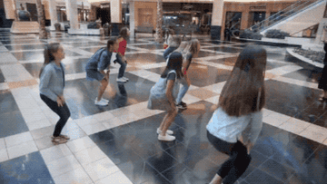 A group of kids rehearsing a dance at a mall