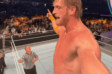 Logan Paul records himself jumping off of the top rope and onto a prone Roman Reigns at WWE Crown Jewel