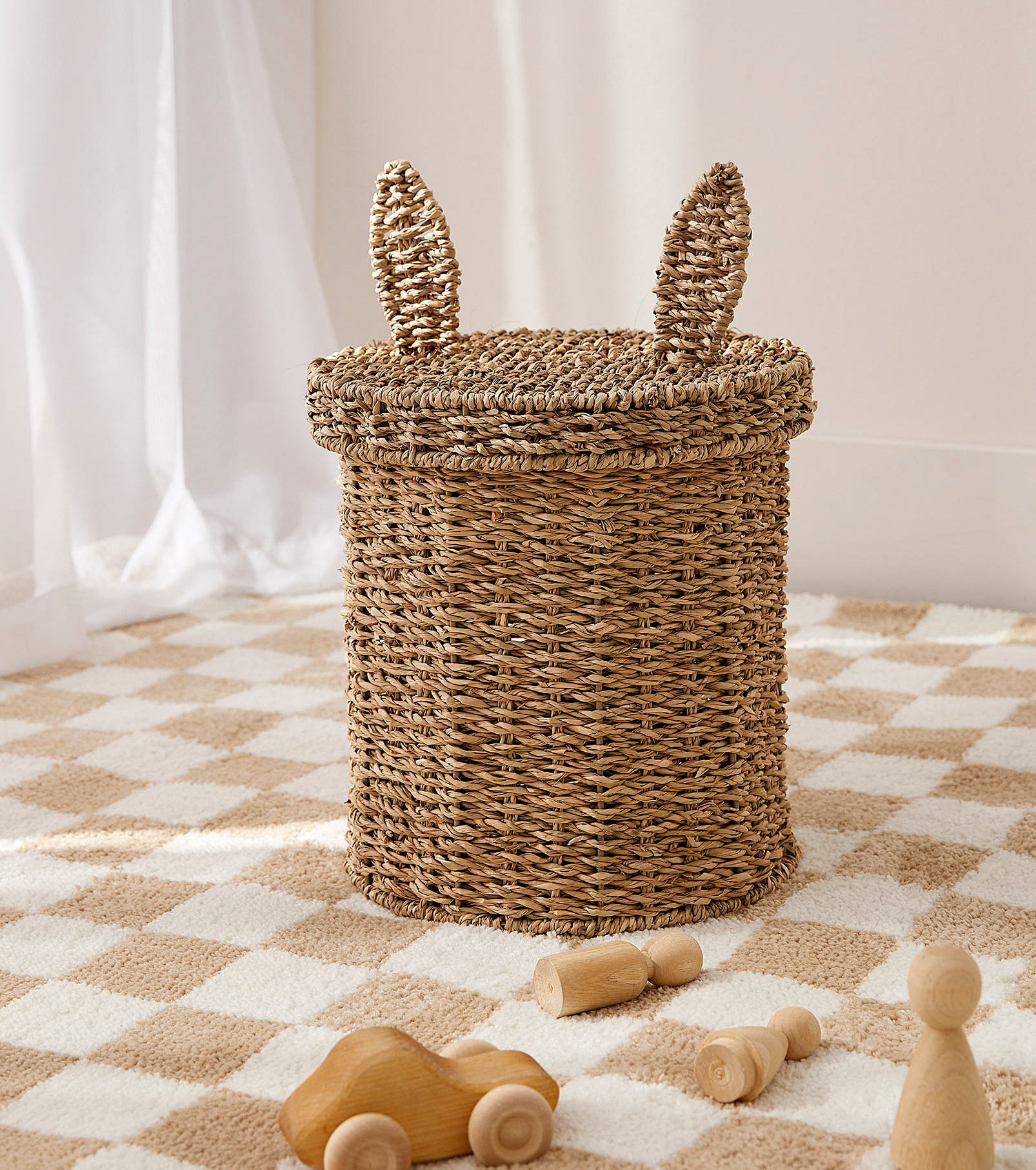 a basket with a lid that has bunny ears on it