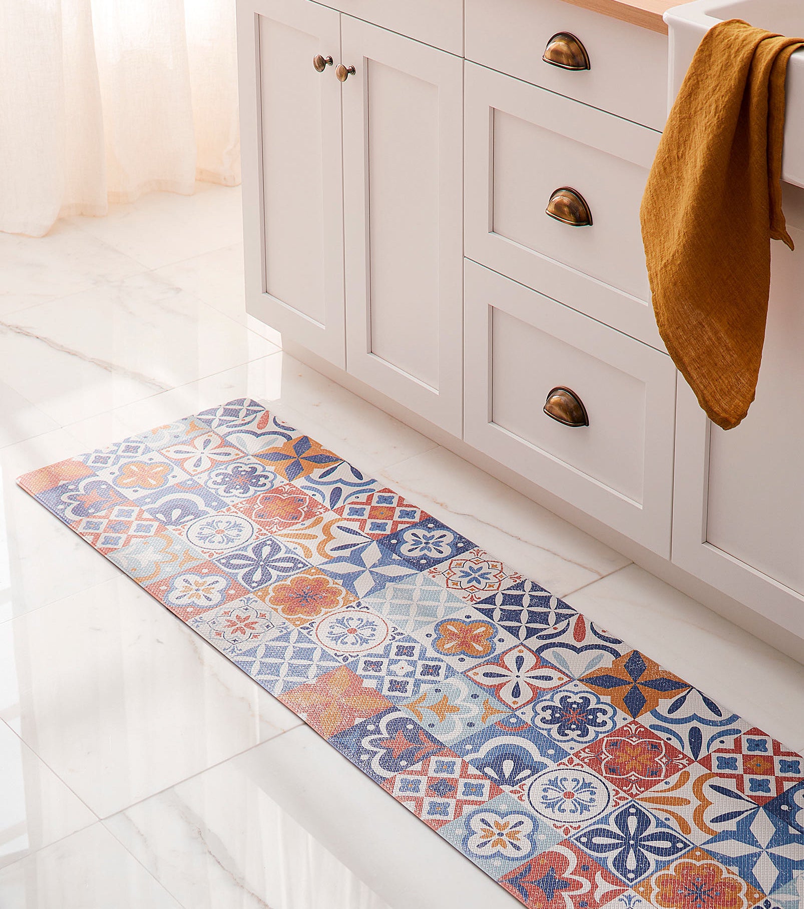 a moroccan-inspired vinyl kitchen mat on a tile floor by a sink