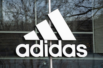 The company's logo hangs on the façade of the Adidas store