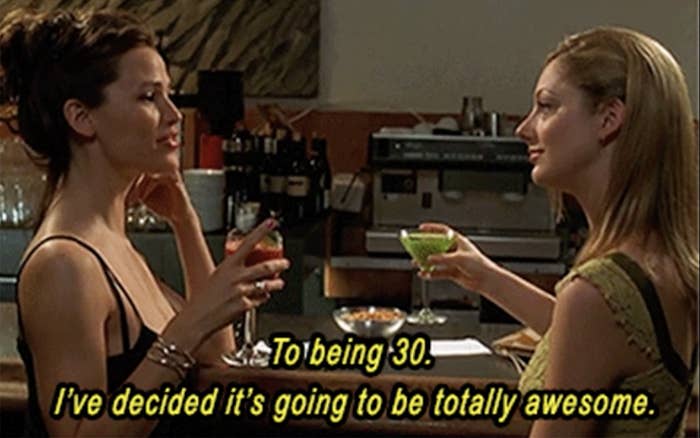 two women in their 30s drinking at a bar