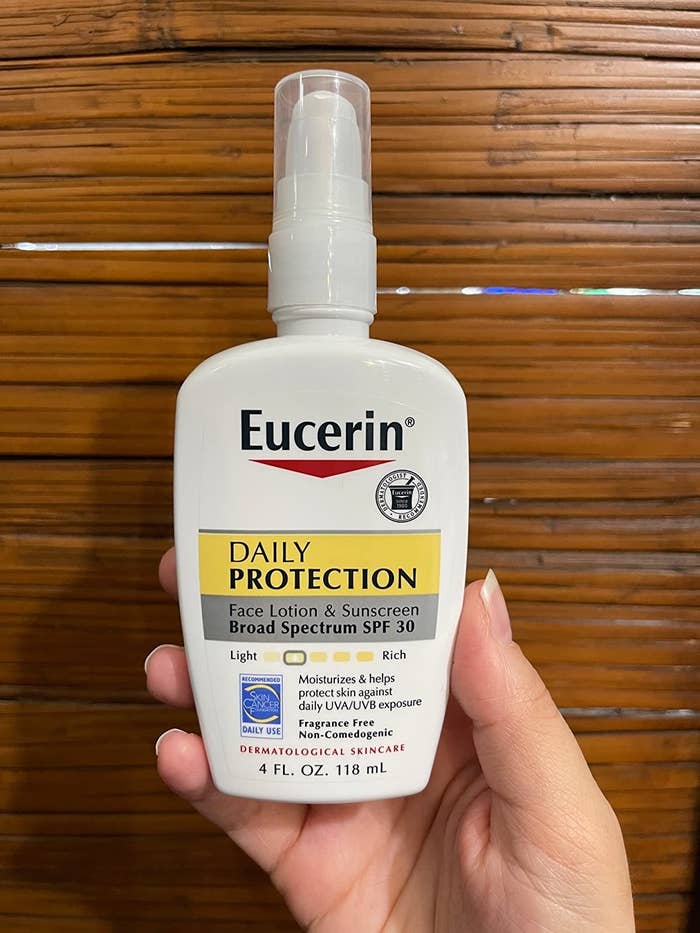 reviewer holding the Eucerin moisturizing sunscreen