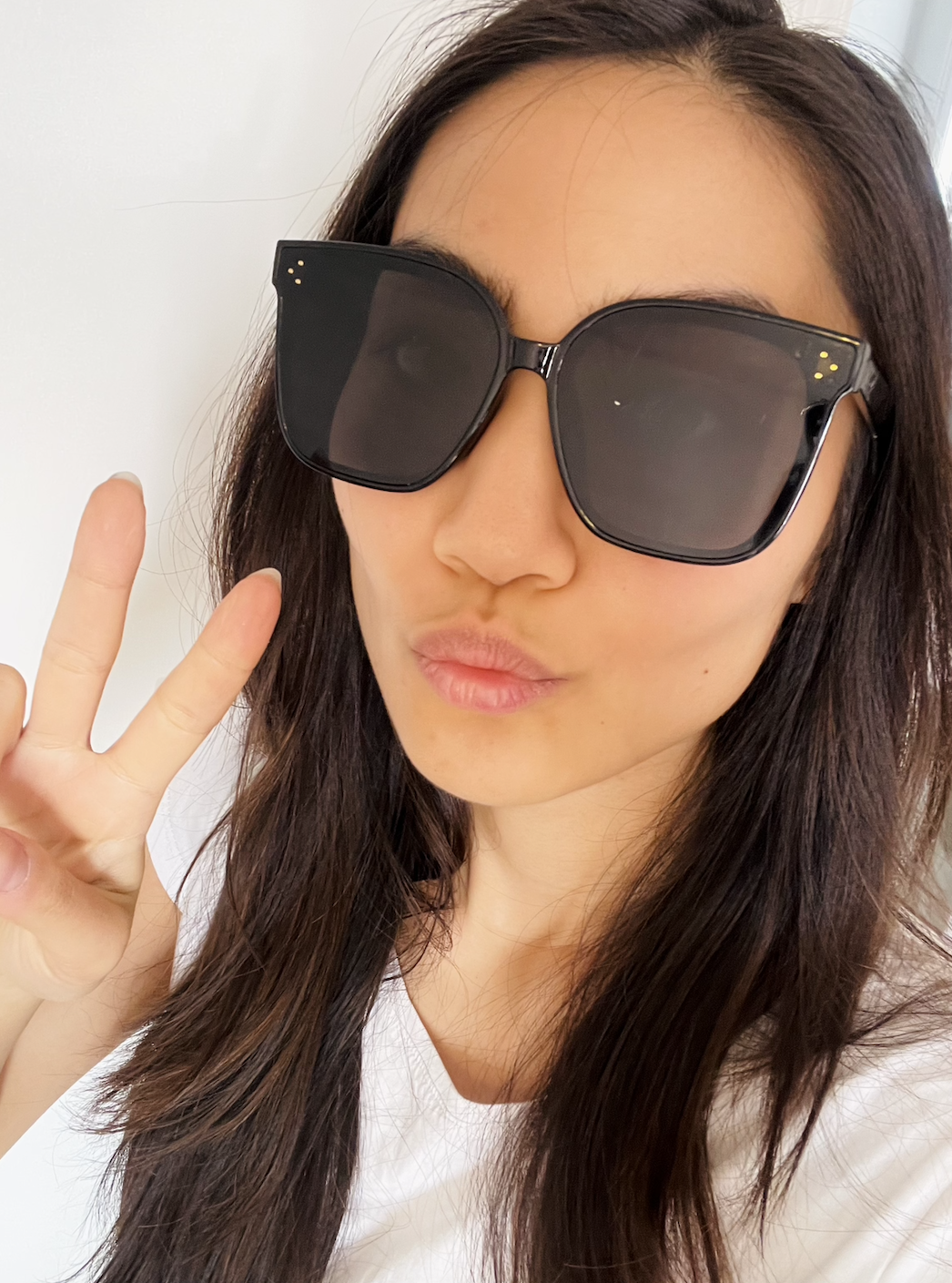 May with the glasses on making a peace sign