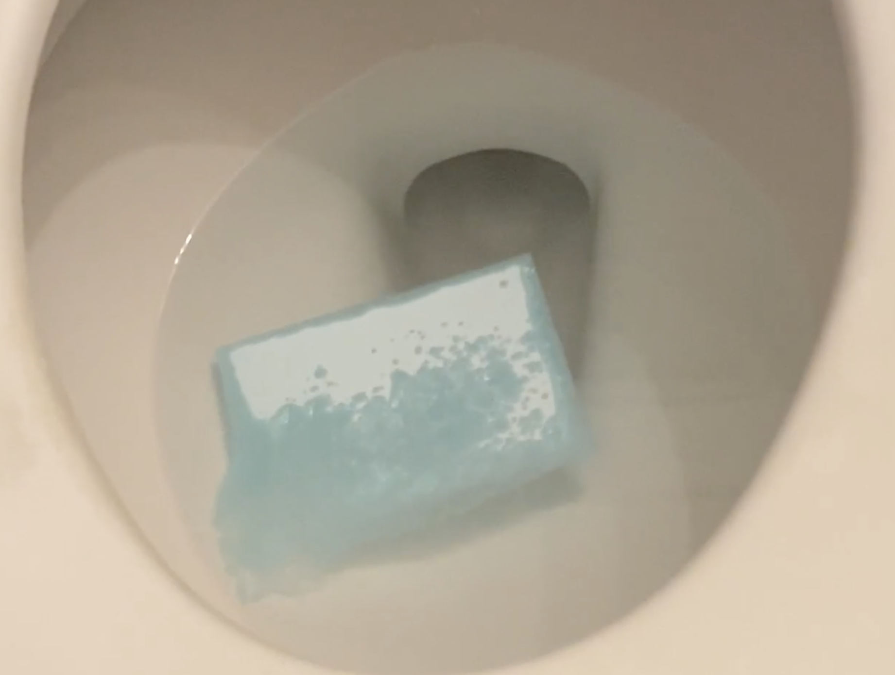 a sheet of the cleaner dissolving in a toilet bowl
