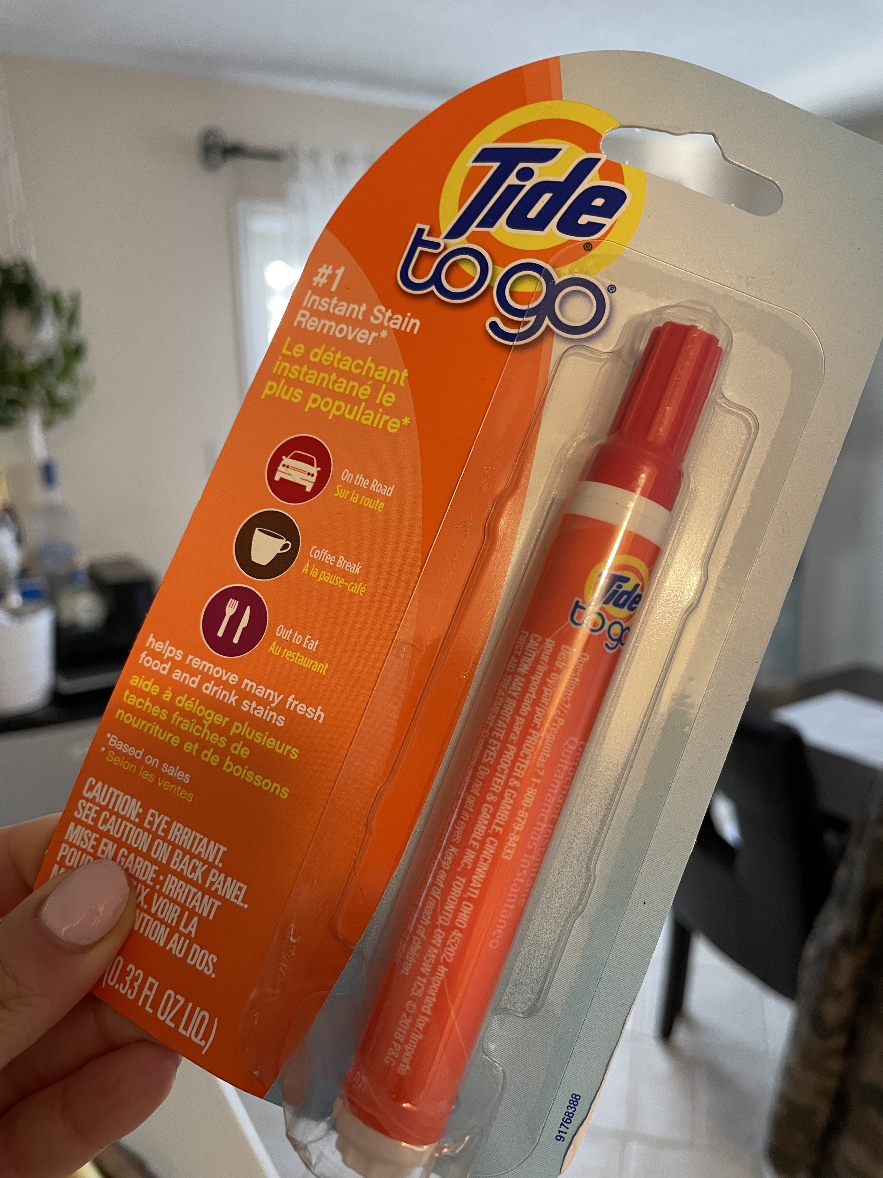May holding the Tide pen in its packaging