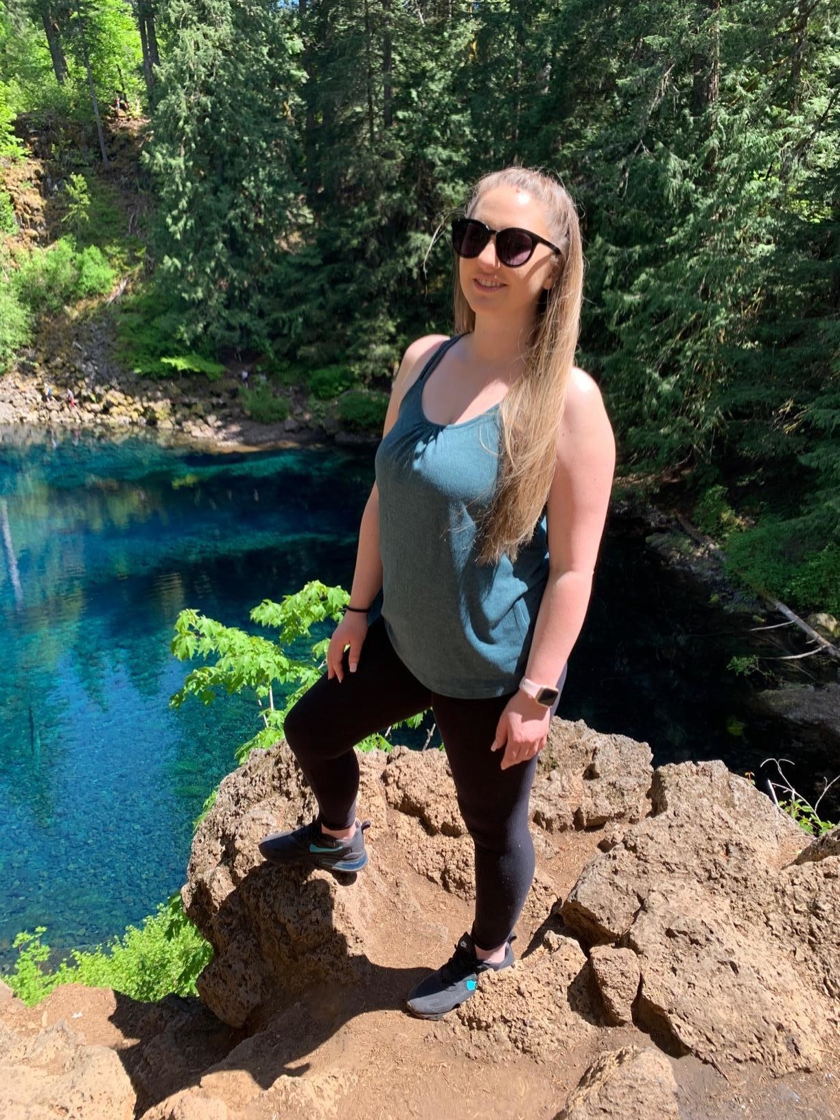 Reviewer wearing the blue tank top and leggings on a hike
