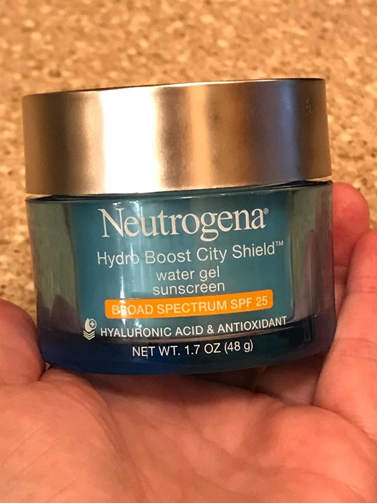 reviewer holding a jar of the Neutrogena Hydro Boost Moisturizer with SPF