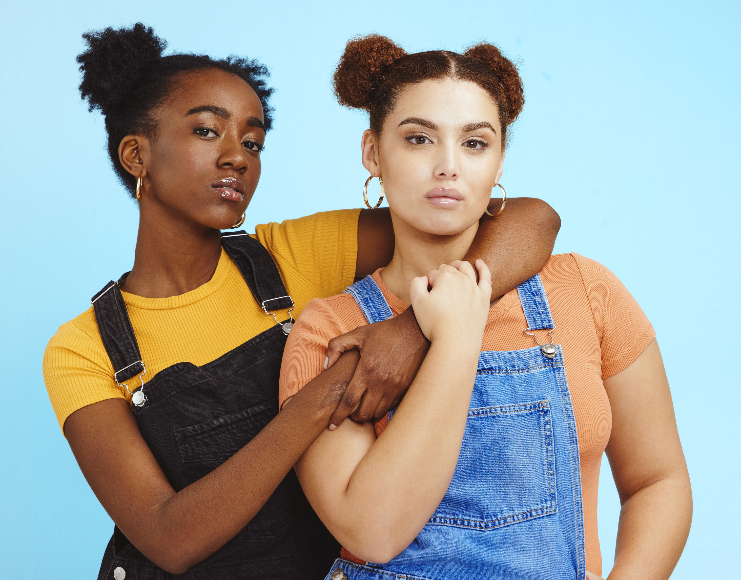 Two women linking arms and hugging