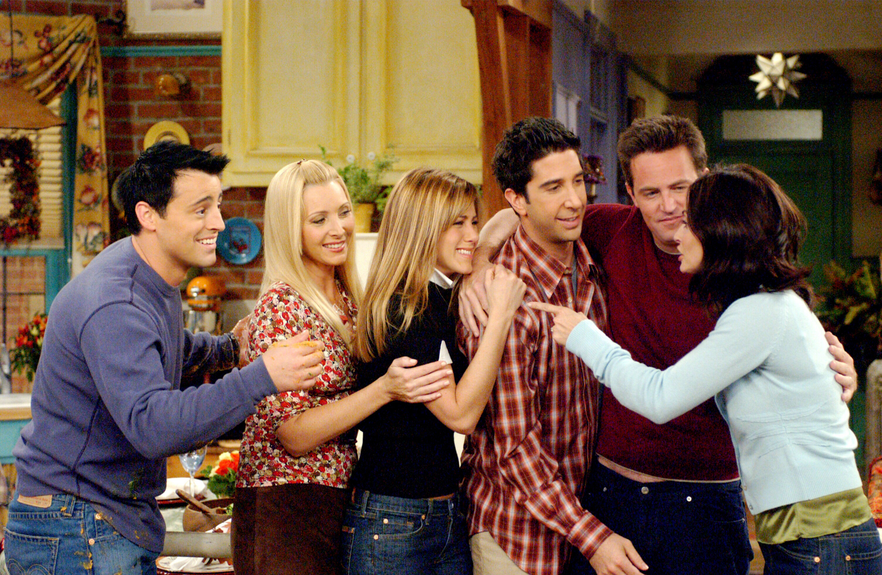 The cast of Friends hugging in a scene