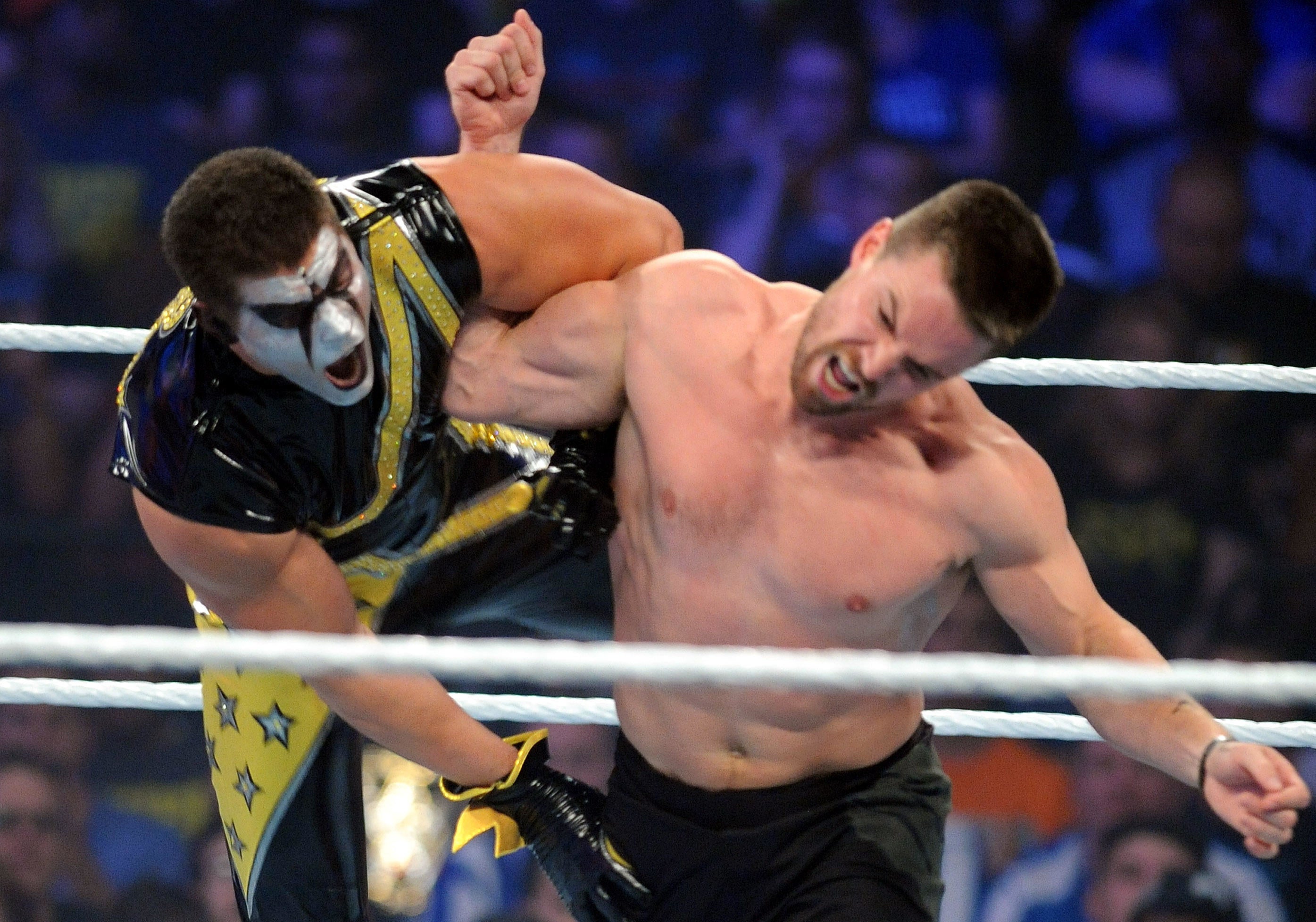 Stephen Amell tosses Stardust during his tag team match with Neville against Stardust and King Barrett at WWE SummerSlam at the Barclays Center on August 23, 2015 in Brooklyn, New York.