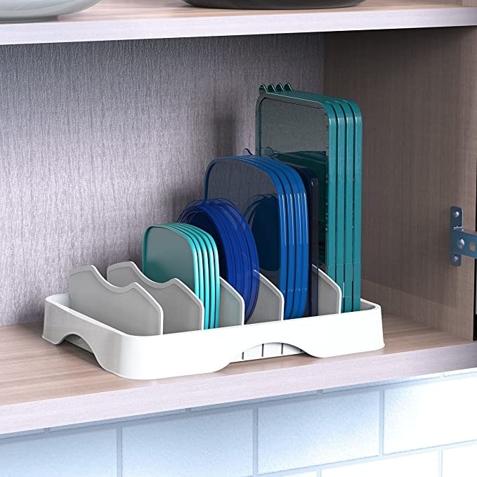 the lid organizer in a kitchen cabinet