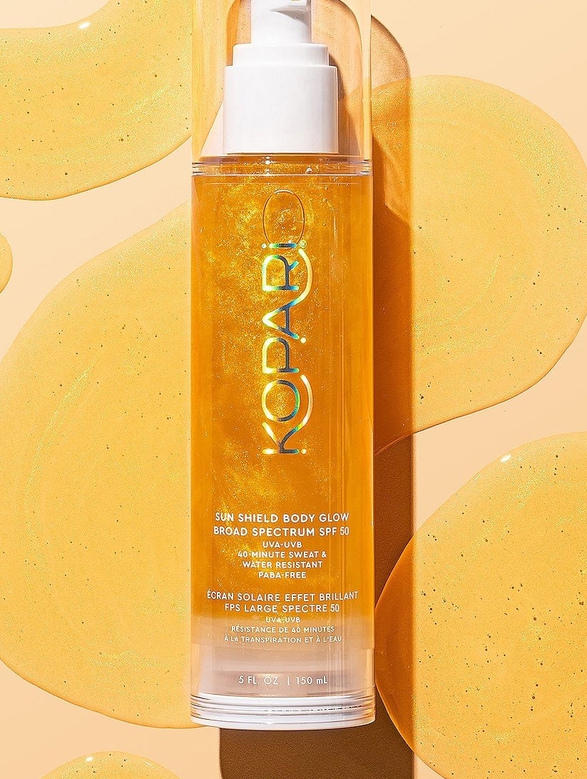 a bottle of kopari sun shield body glow on a vibrant background