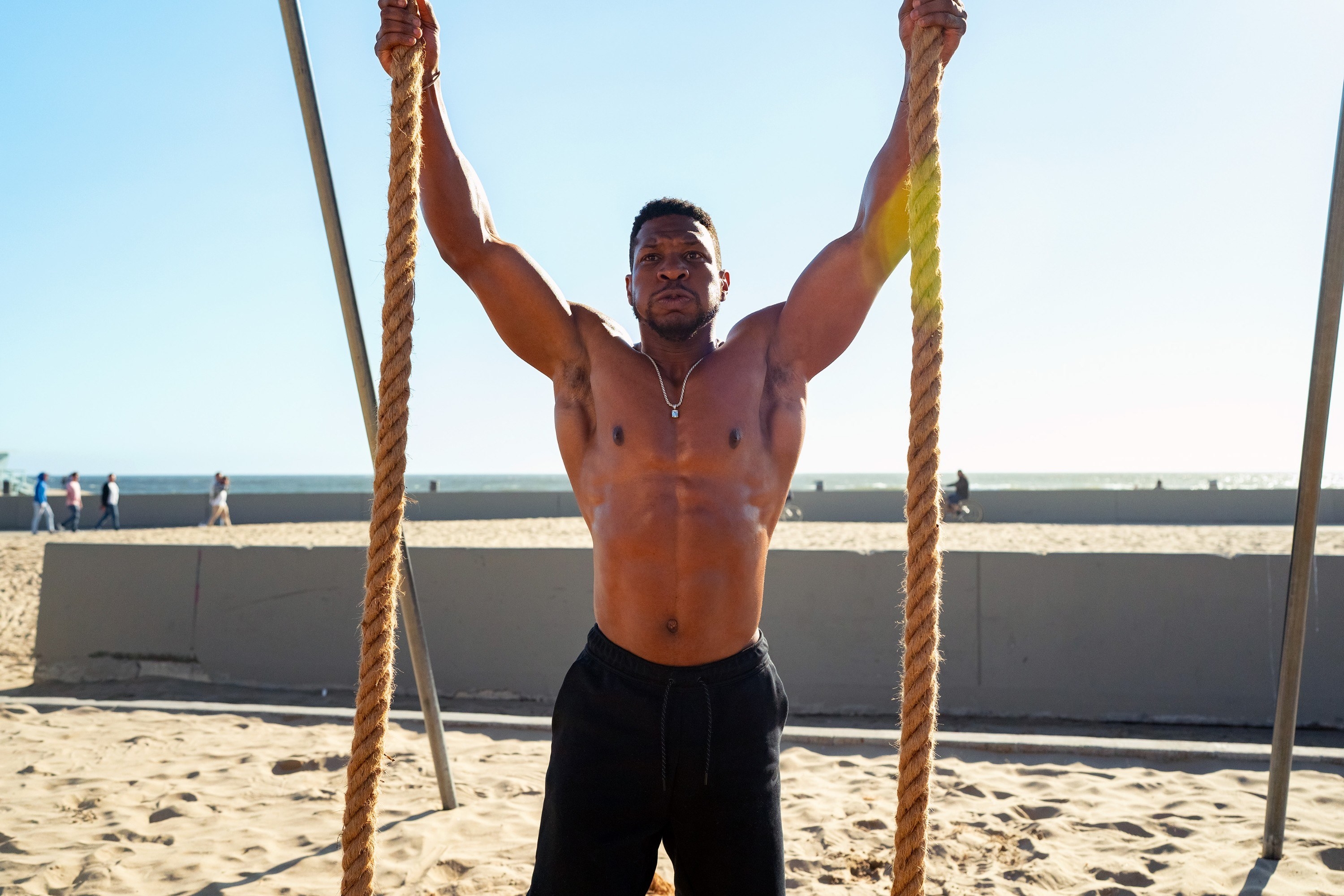 Majors on the beach holding up ropes for a workout