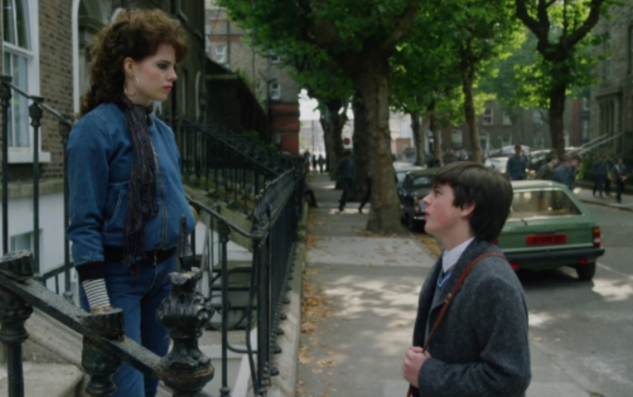 scene from the film where the man is talking to the girl on the steps of her apartment