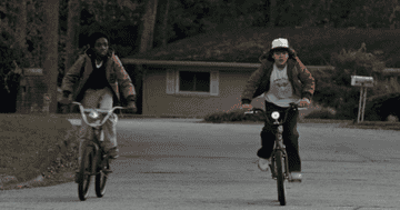 two kids riding bikes