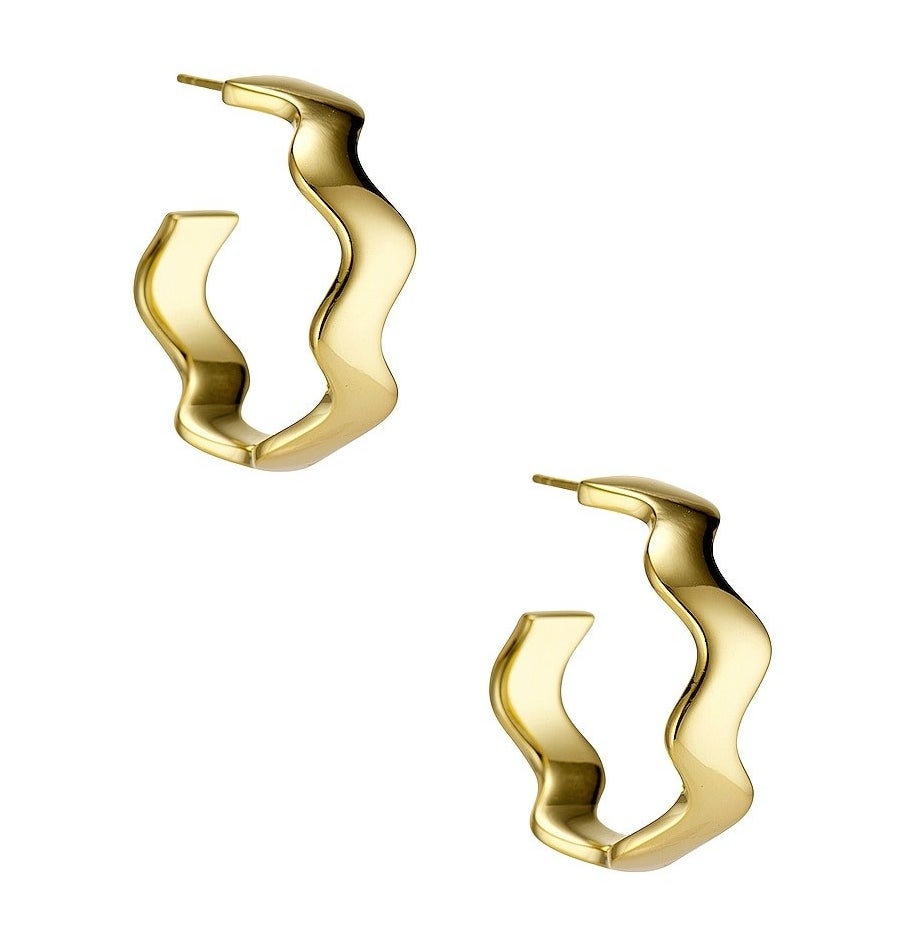 a pair of wavy gold hoops on a blank background