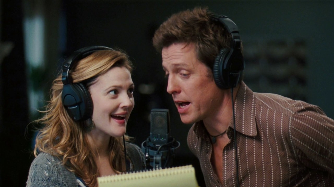 scene from the film where Alex and Sophie are singing into the same microphone