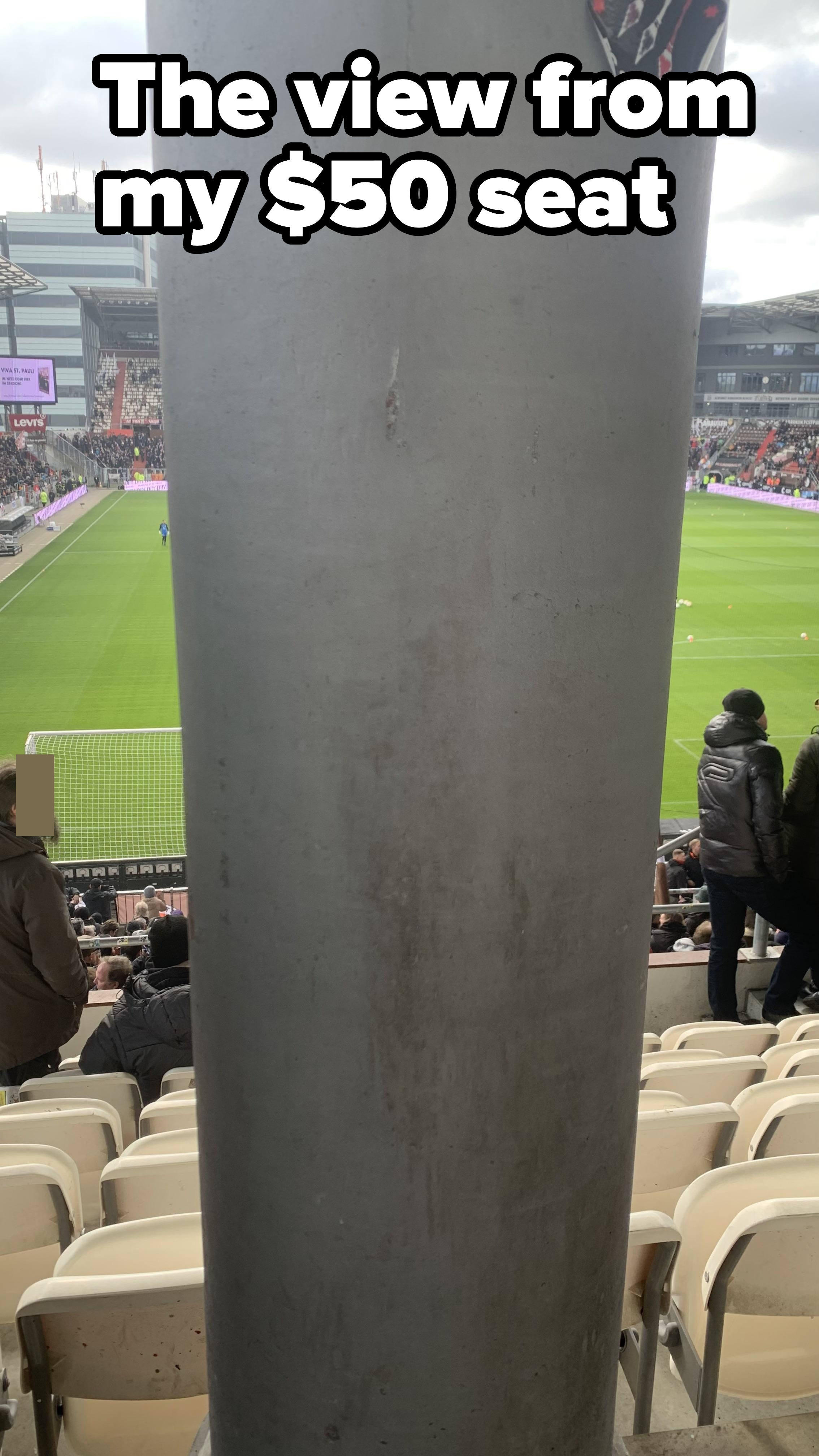 Seat directly behind a huge pole at a sports stadium