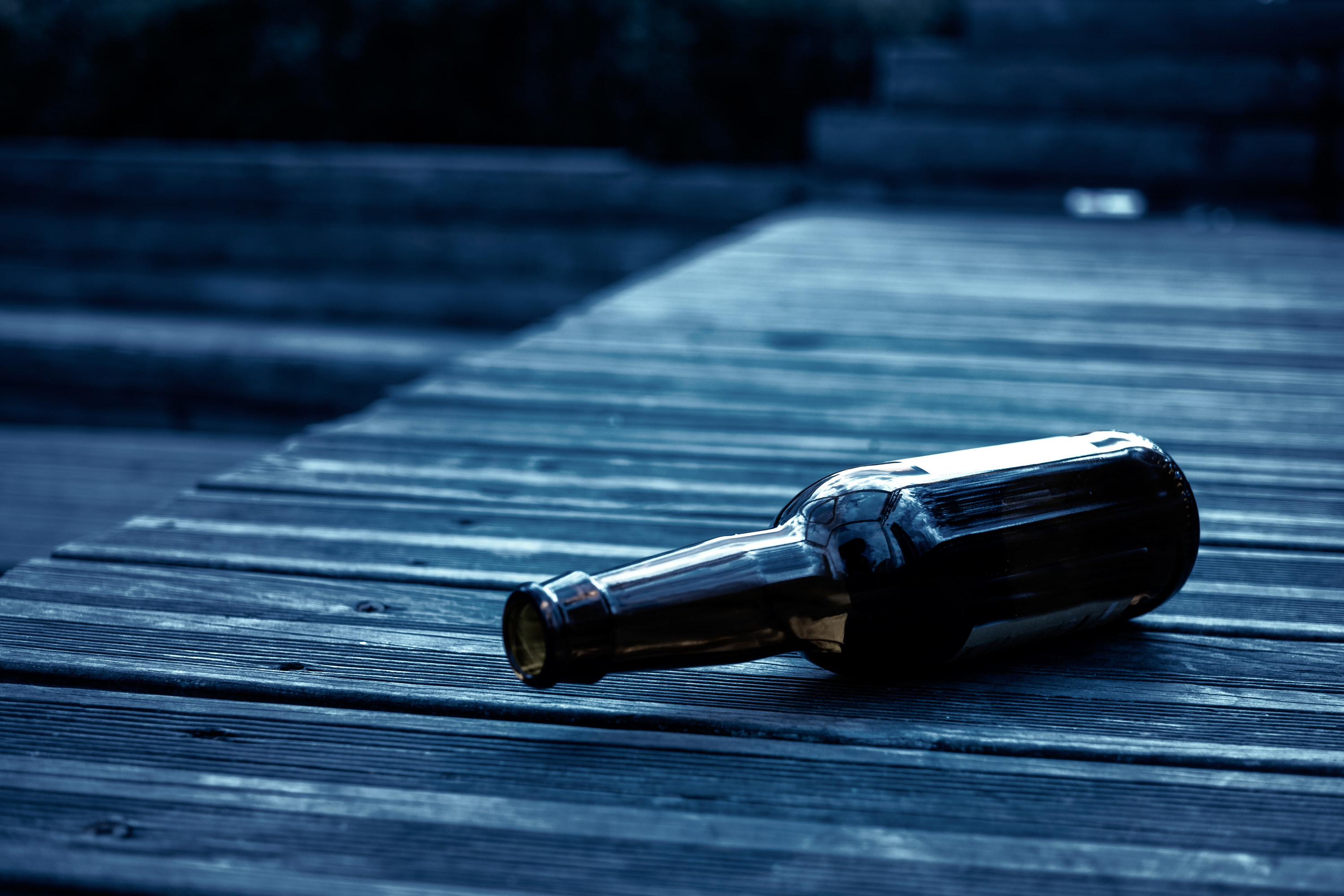 empty bottle on a deck floor