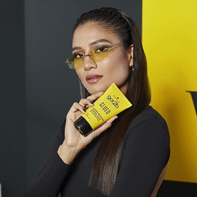 a model holding the yellow bottle of product