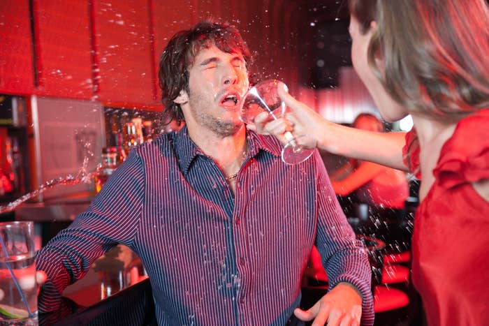 person throwing a drink in someone's face