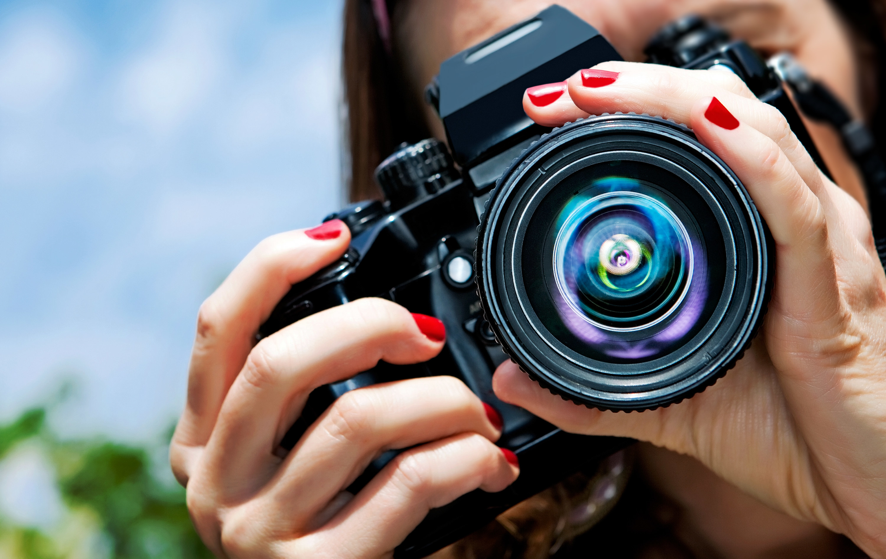 Woman adjusting lens on a camera