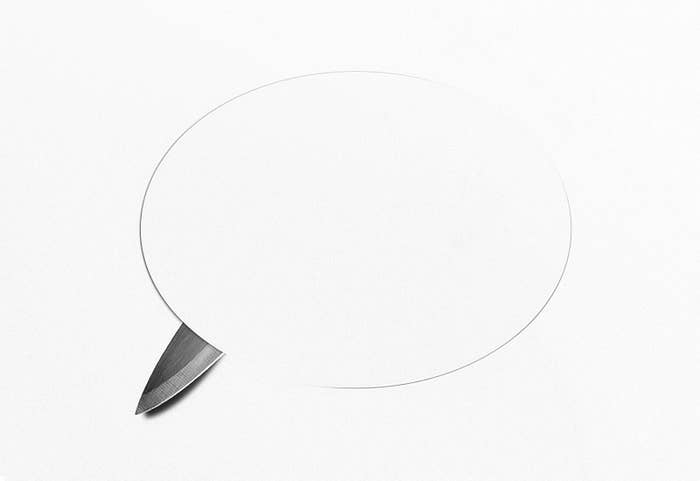a knife cutting through paper that looks like a speech bubble