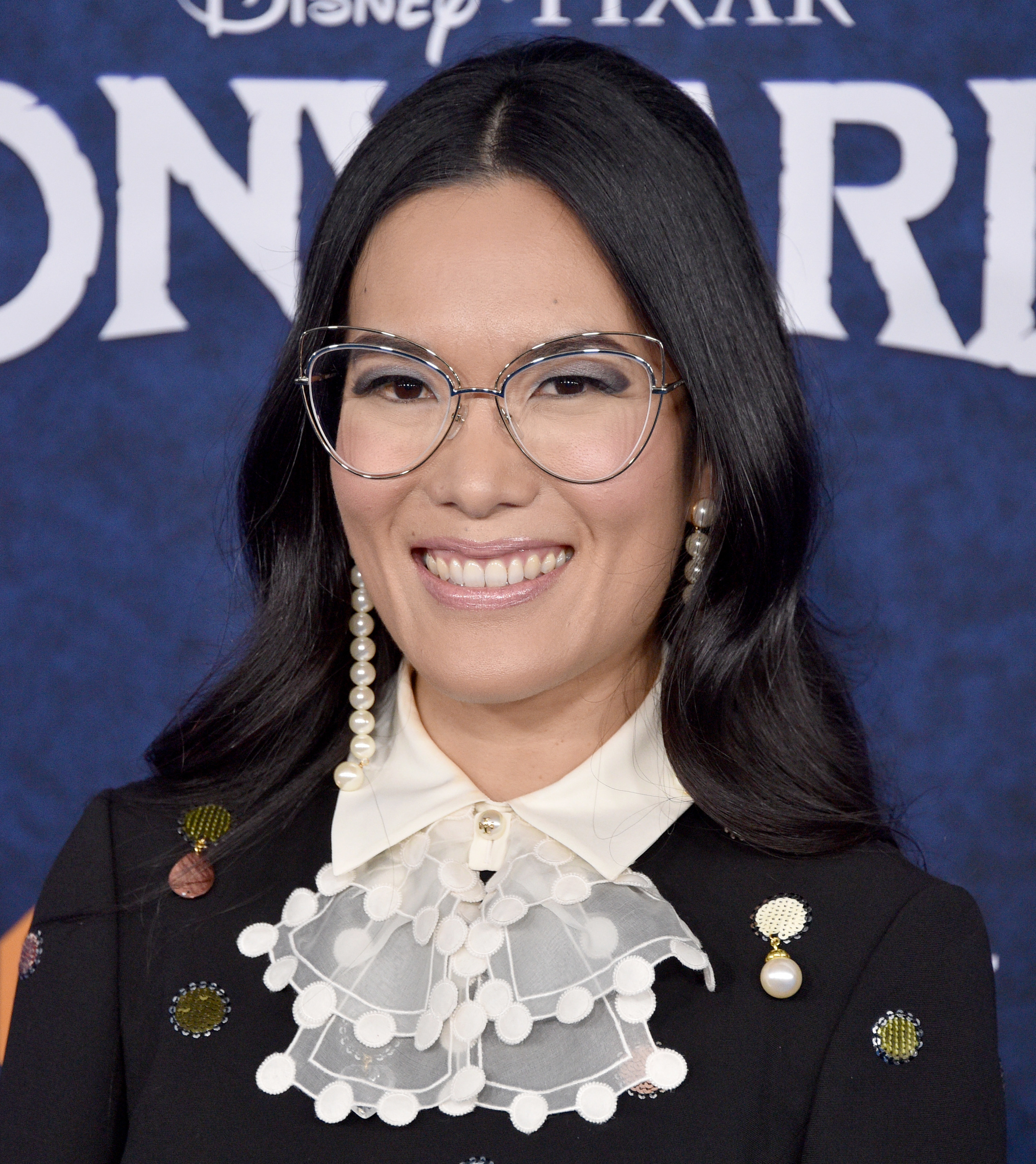 A closeup of Ali Wong smiling at a red carpet event.