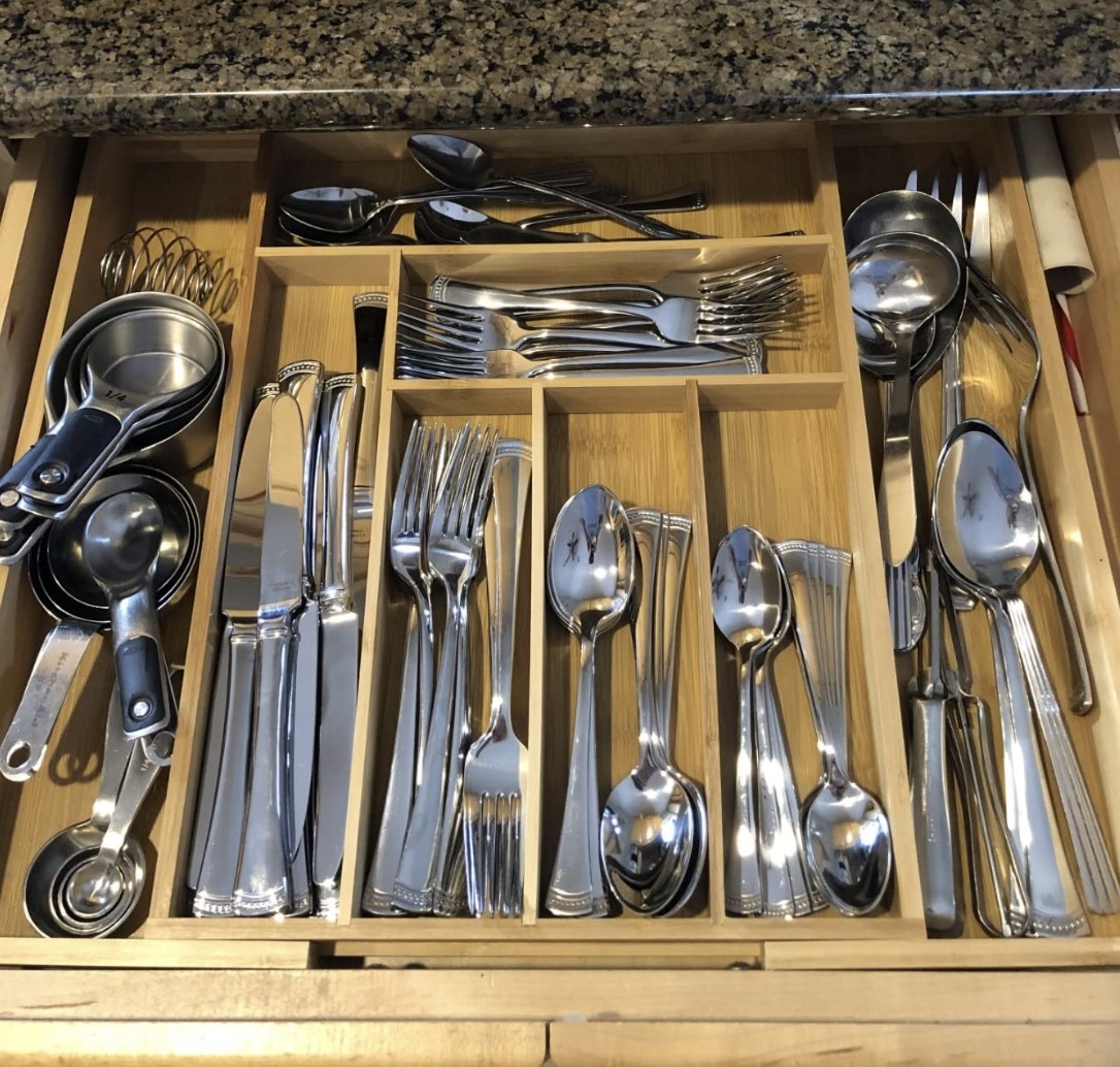 reviewer photo showing their silverware neatly organized in the bamboo drawer organizer