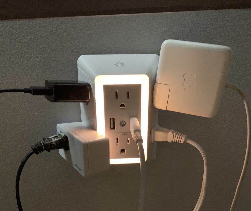 Charger with several large plugs in it