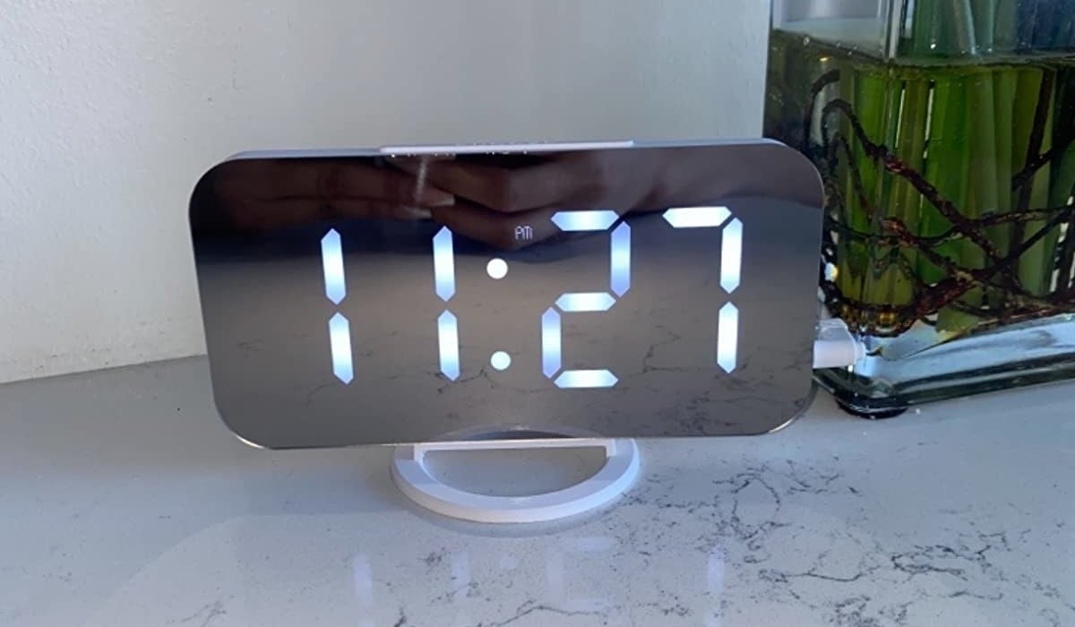 a reviewer photo of a digital alarm clock