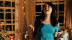 a gif of emma stone dancing triumphantly in easy a