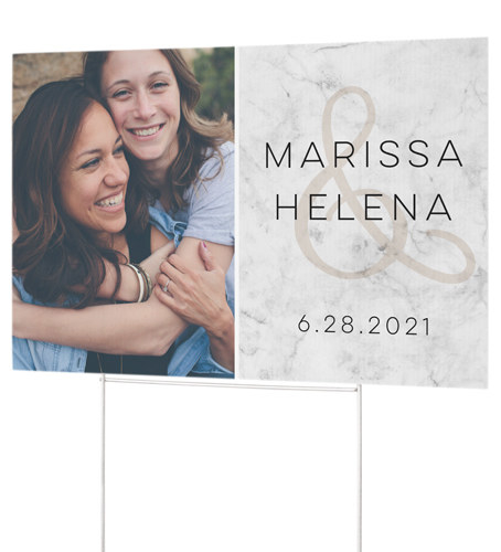 Yard sign with picture of couple, wedding date, and name of couple written on it