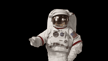 An astronaut tapping their head