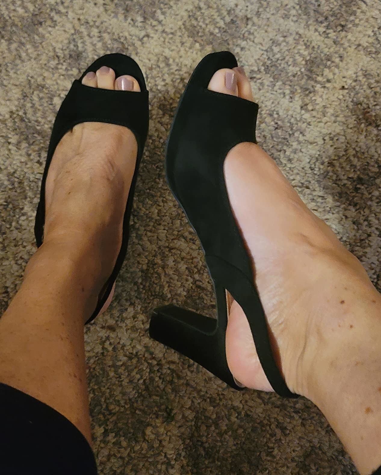 A reviewer wearing black heels