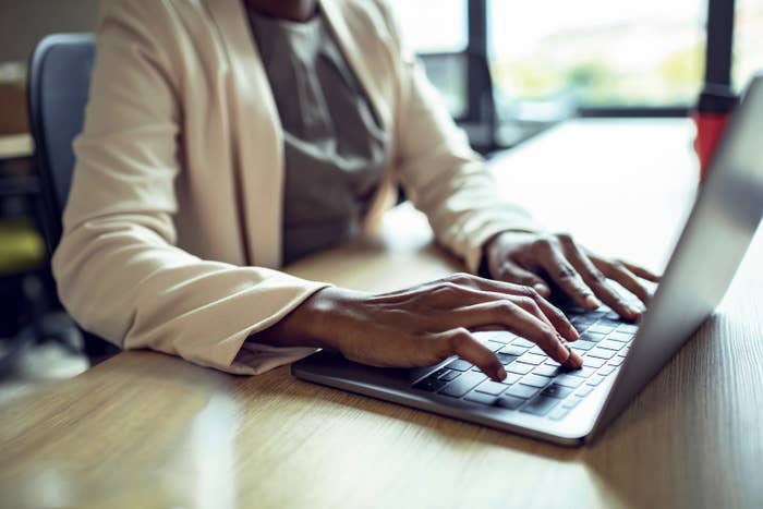 hands typing on a laptop