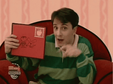 Steve from &quot;Blues Clues&quot; pointing at a letter from the mail