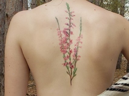 back tattoo of pink heather flowers