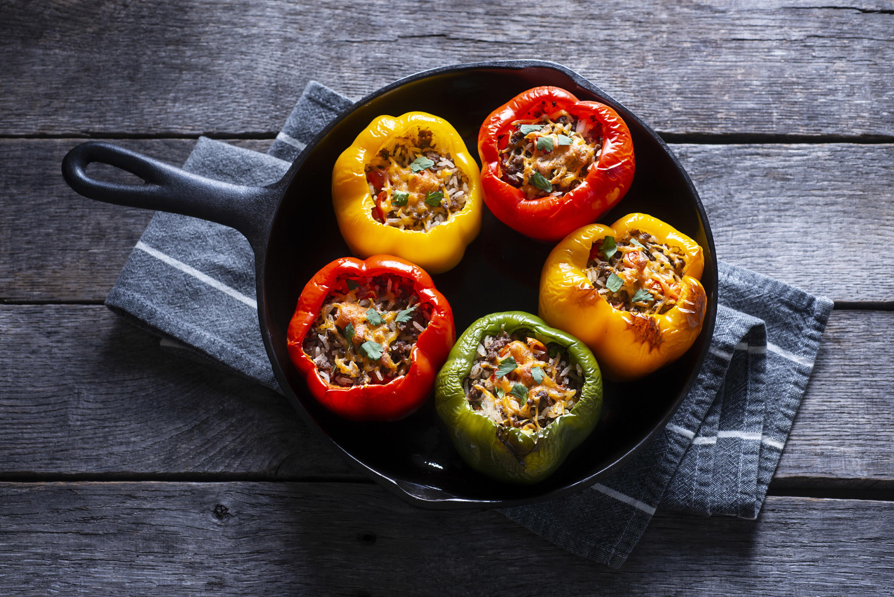 stuffed bell peppers in a cast iron skillet