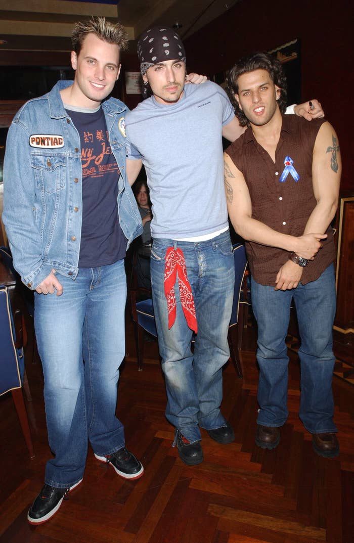 The band in jeans and embracing at an event