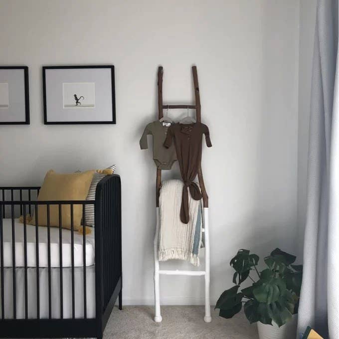 a reviewer photo of the ladder next to a crib