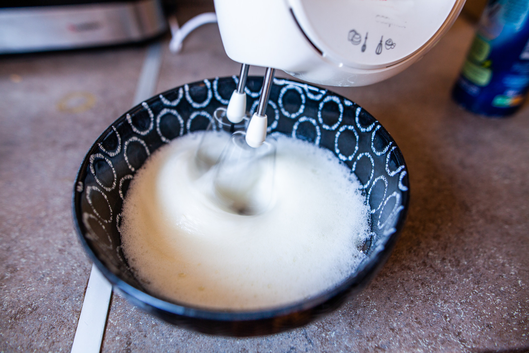 Beating egg whites in a bowl.